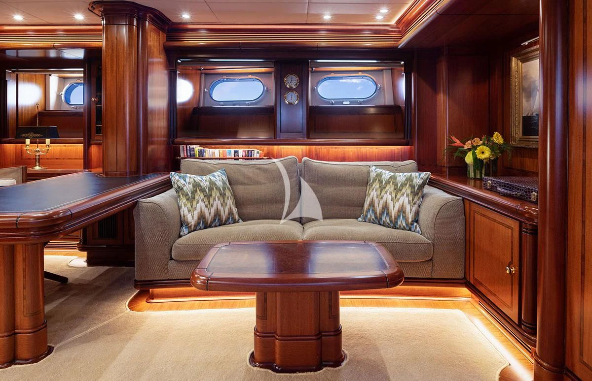 a living room with a couch and a table aboard HYPERION Yacht for Charter