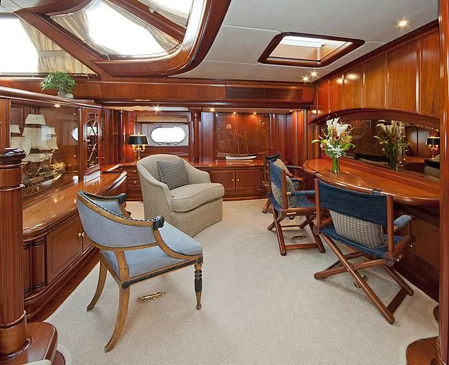 a living room with a table and chairs aboard HYPERION Yacht for Charter