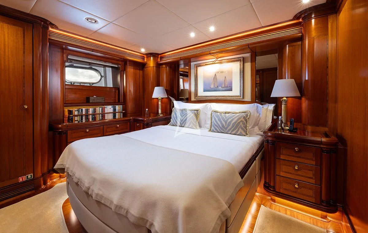 a bedroom with a bed and a desk aboard HYPERION Yacht for Charter