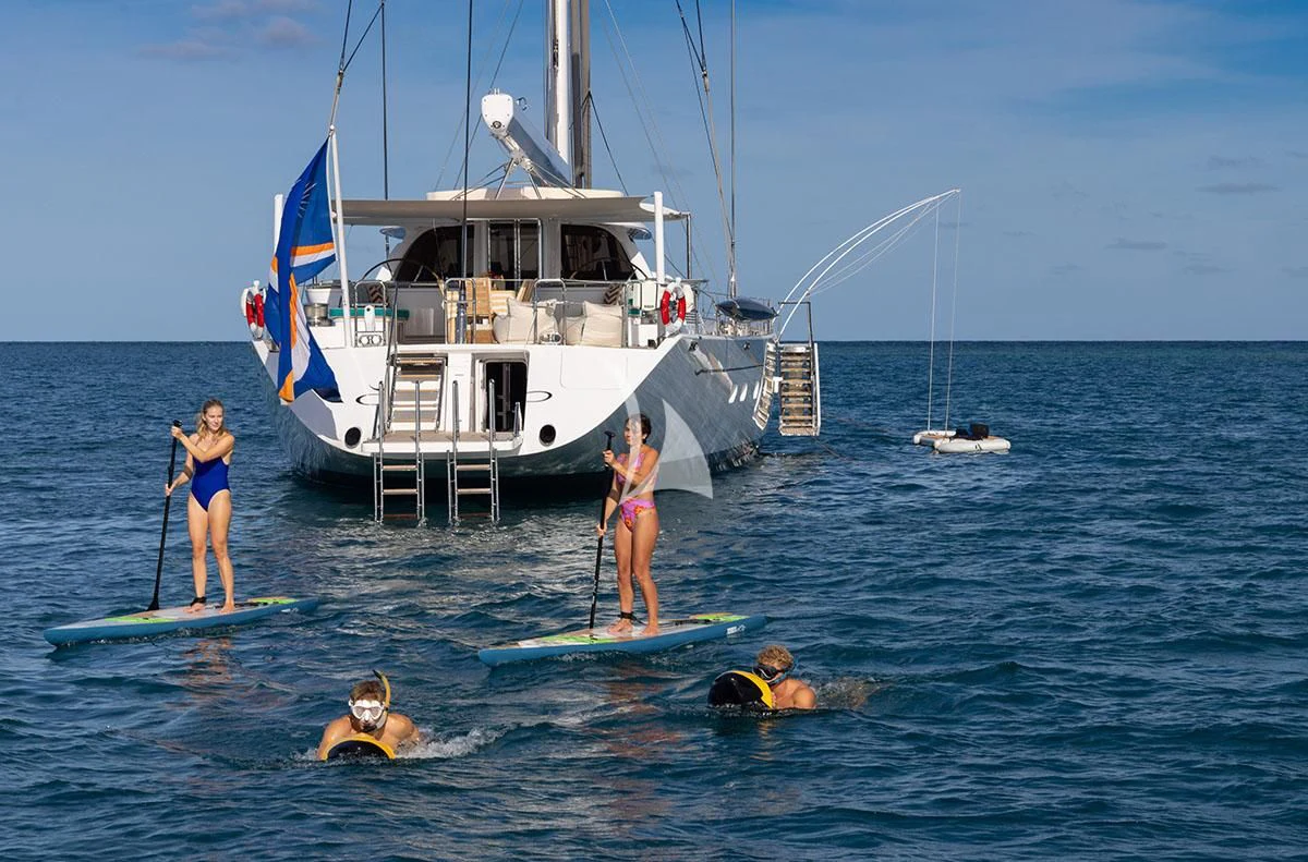 people on surfboards in the water aboard HYPERION Yacht for Charter