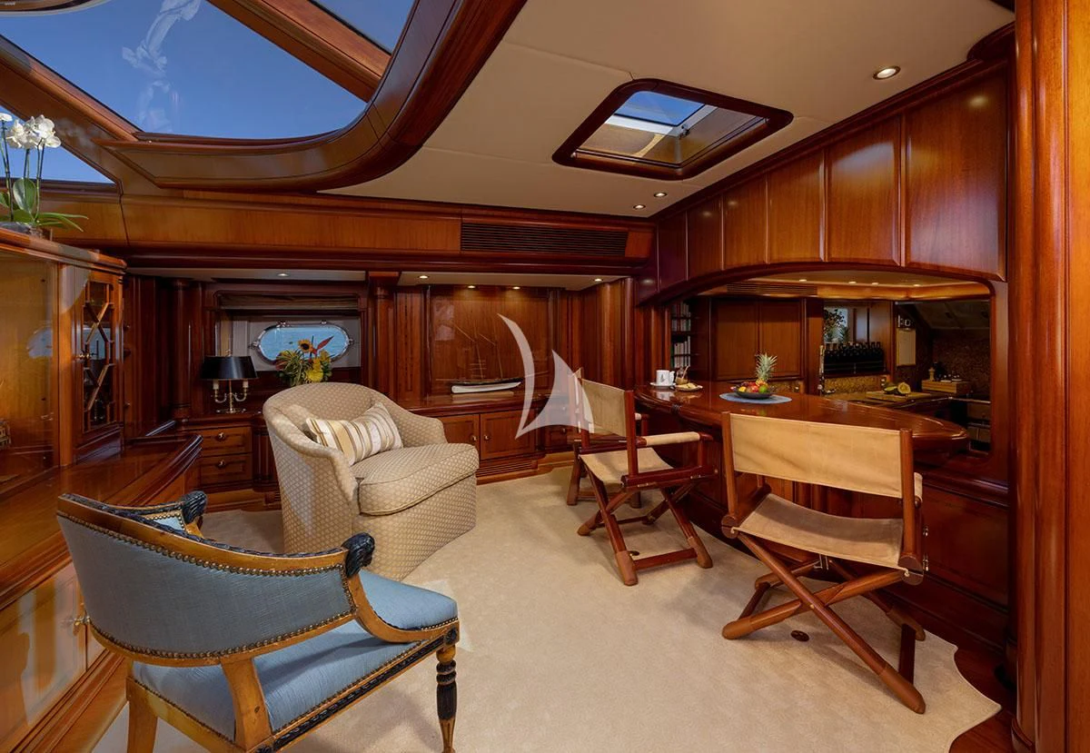 a living room with a kitchen and dining area aboard HYPERION Yacht for Charter