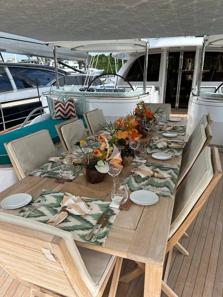 a table with plates and glasses on it aboard HYPERION Yacht for Charter