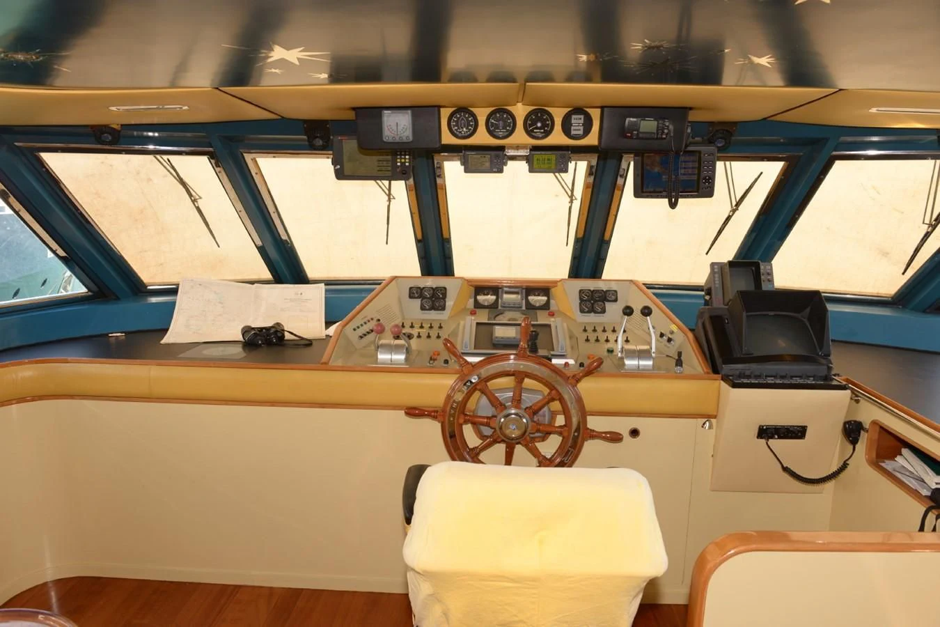 a wooden desk with a chair and a steering wheel aboard MISTER P Yacht for Sale
