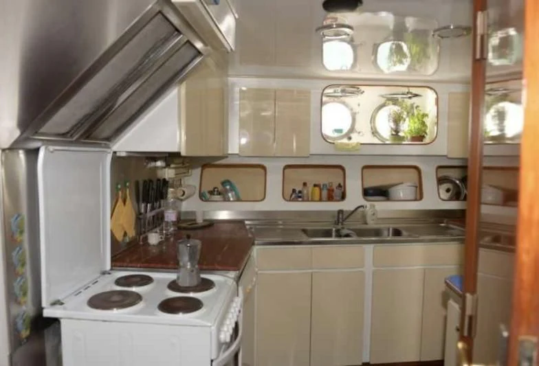 a kitchen with a stove and a sink aboard MISTER P Yacht for Sale