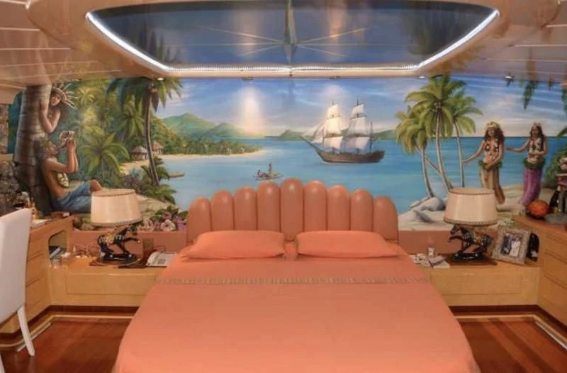 a room with a large bed and a large fish tank aboard MISTER P Yacht for Sale