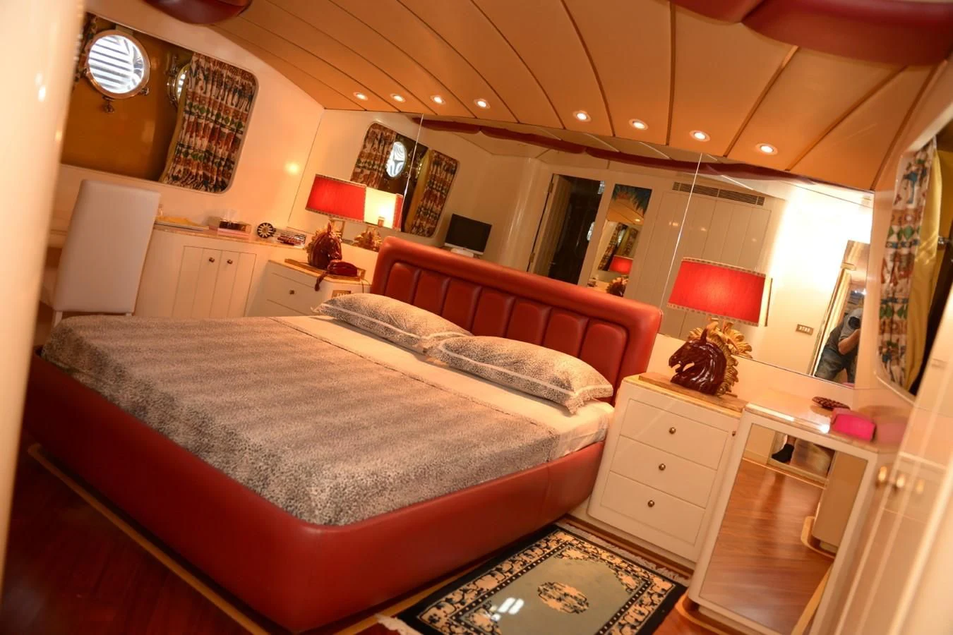 a bedroom with a bed and a desk aboard MISTER P Yacht for Sale