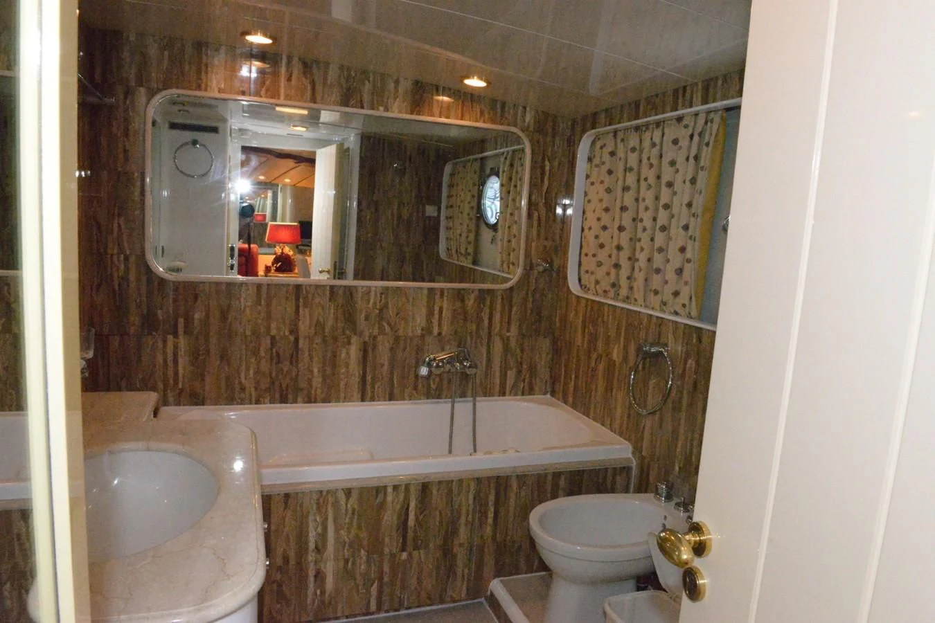 a bathroom with a tub sink and toilet aboard MISTER P Yacht for Sale