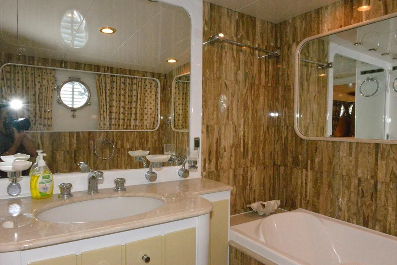 a bathroom with a tub sink and mirror aboard MISTER P Yacht for Sale