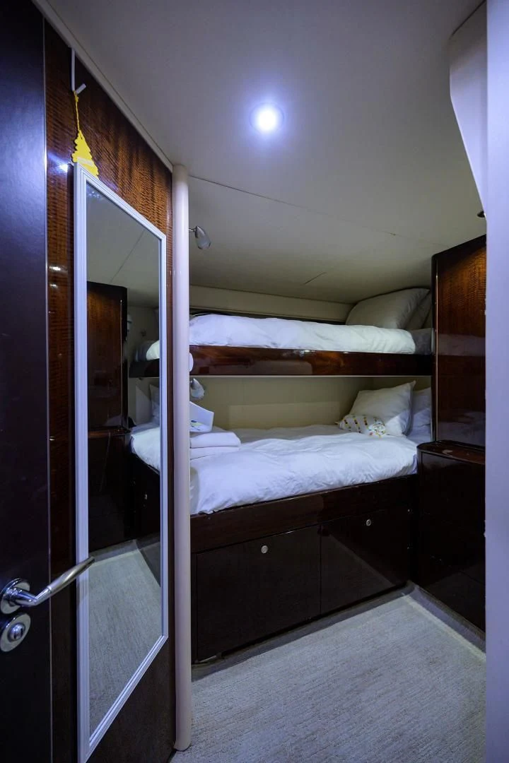 a bedroom with a bed and a mirror aboard THE JOB FATHER Yacht for Sale