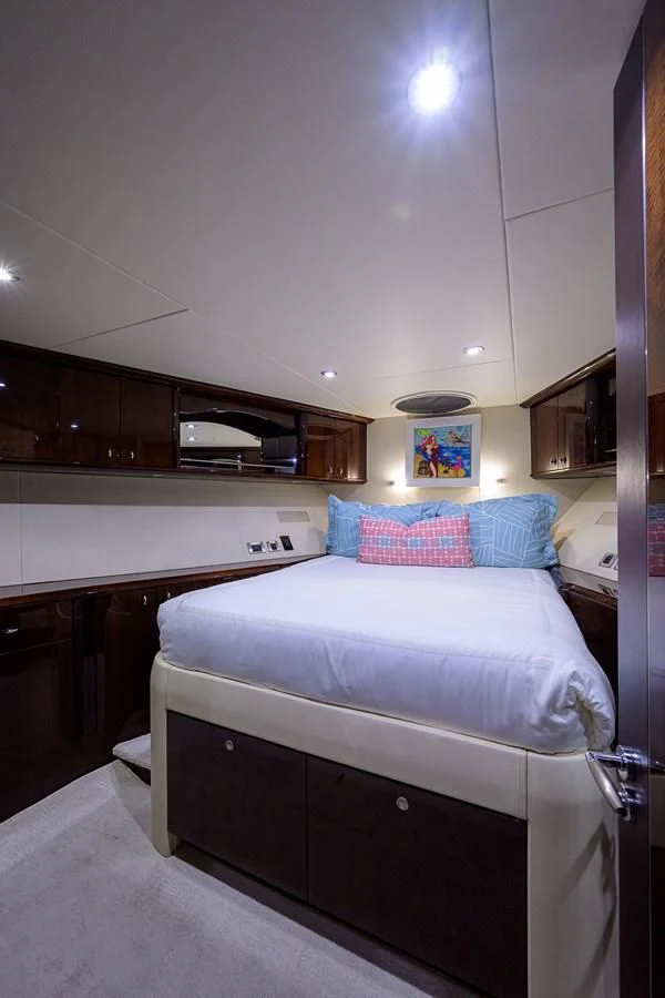 a bedroom with a bed and a television aboard THE JOB FATHER Yacht for Sale