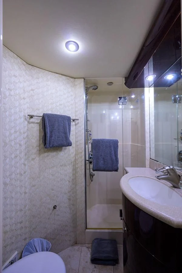 a bathroom with a shower curtain aboard THE JOB FATHER Yacht for Sale