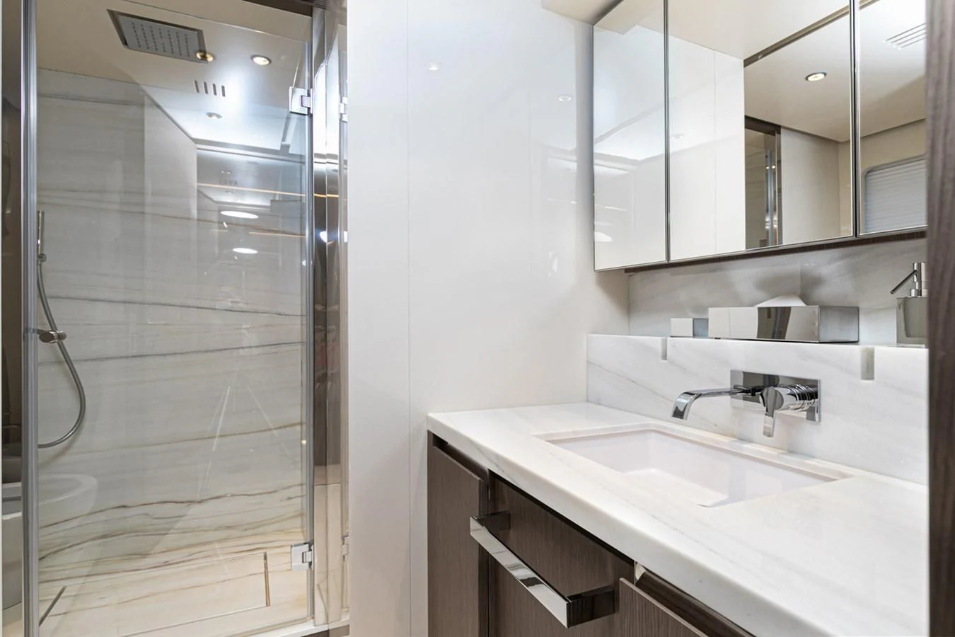 a bathroom with a sink and mirror aboard JAG'B Yacht for Sale