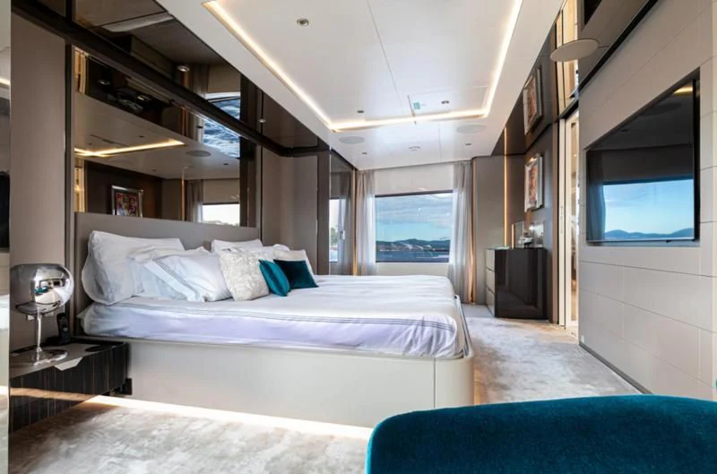 a bedroom with a bed and a television aboard JAG'B Yacht for Sale