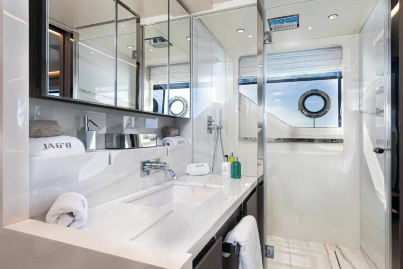a bathroom with a sink and mirror aboard JAG'B Yacht for Sale
