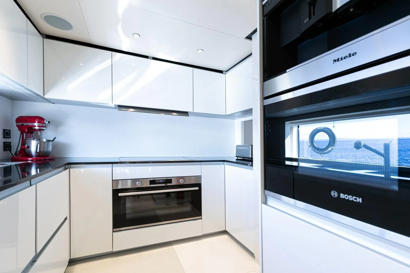 a kitchen with white cabinets aboard JAG'B Yacht for Sale