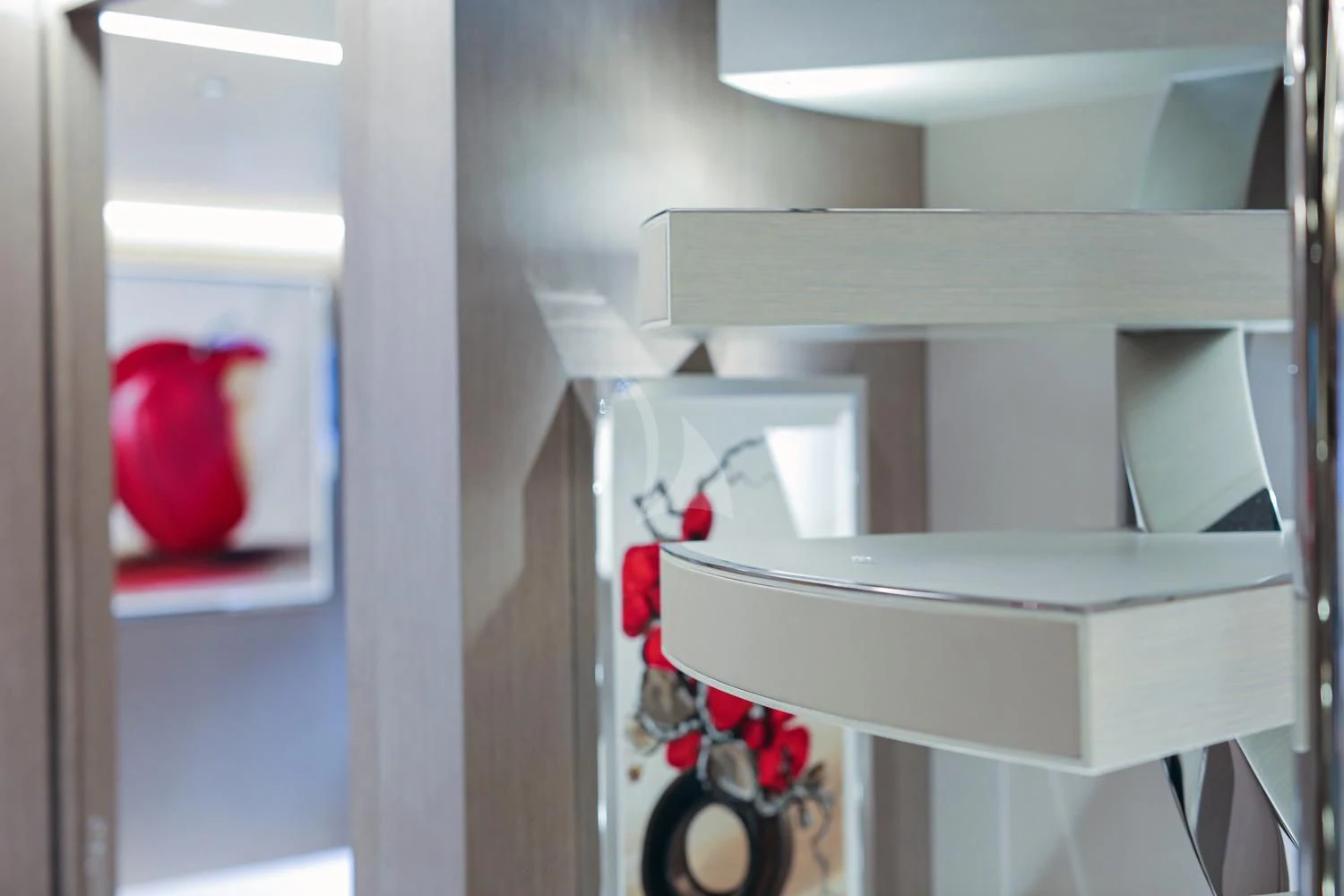 a red and white vase on a white shelf aboard JAG'B Yacht for Sale