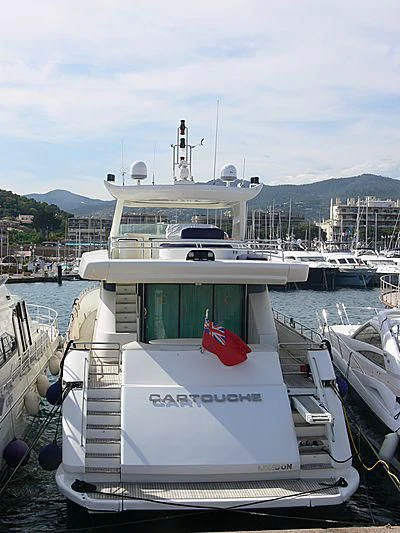 a boat docked at a pier aboard CARTOUCHE Yacht for Sale