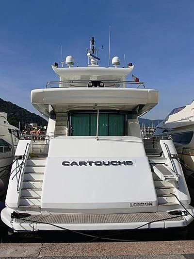 a white boat with blue doors aboard CARTOUCHE Yacht for Sale