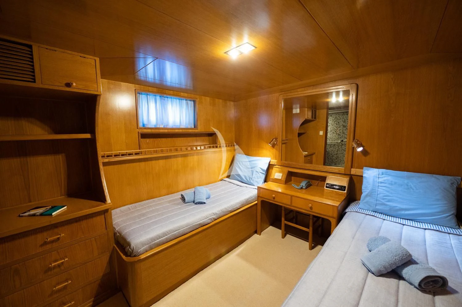a room with beds and a dresser aboard ELENA Yacht for Sale