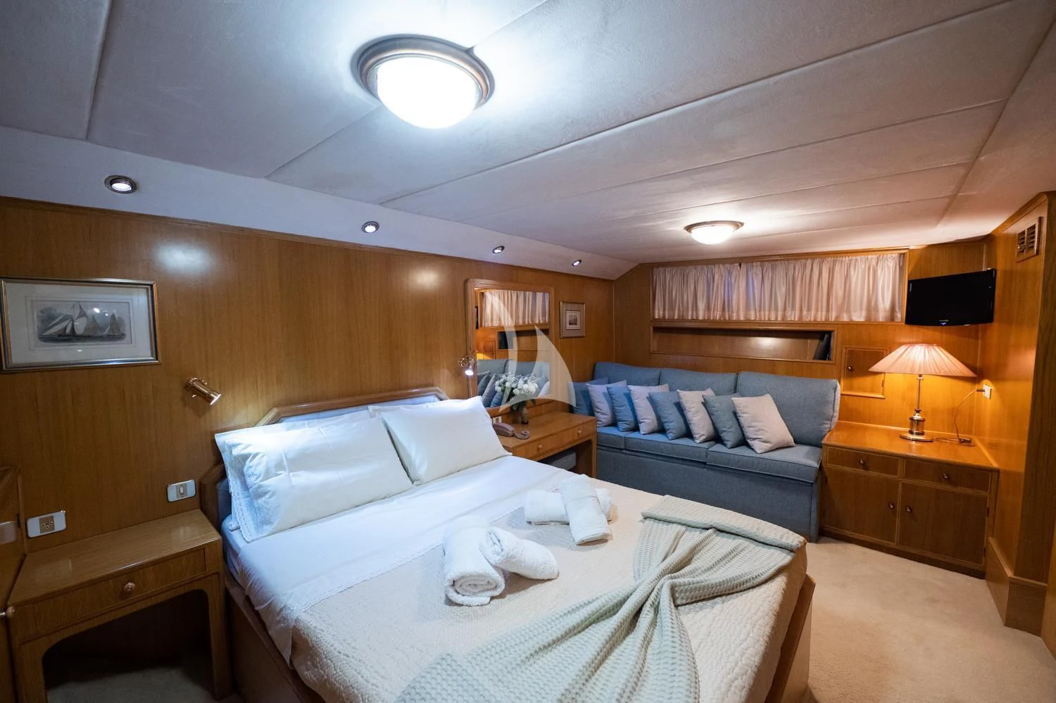 a hotel room with a bed and a couch aboard ELENA Yacht for Sale