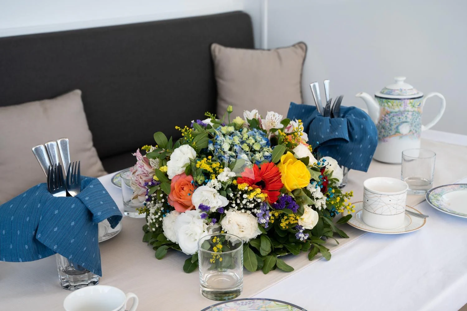 a table with flowers and plates aboard ELENA Yacht for Sale