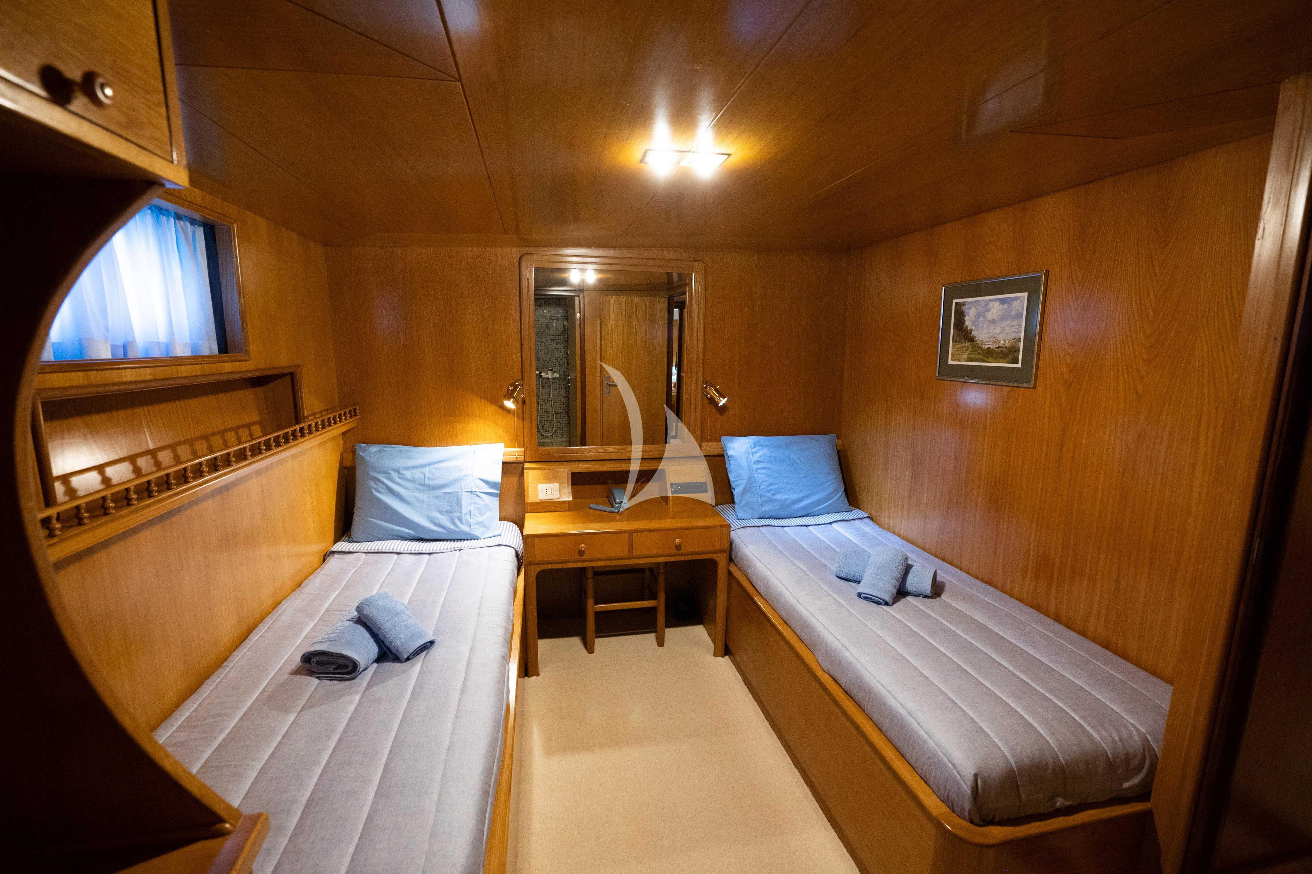 a room with a bed and a desk aboard ELENA Yacht for Sale