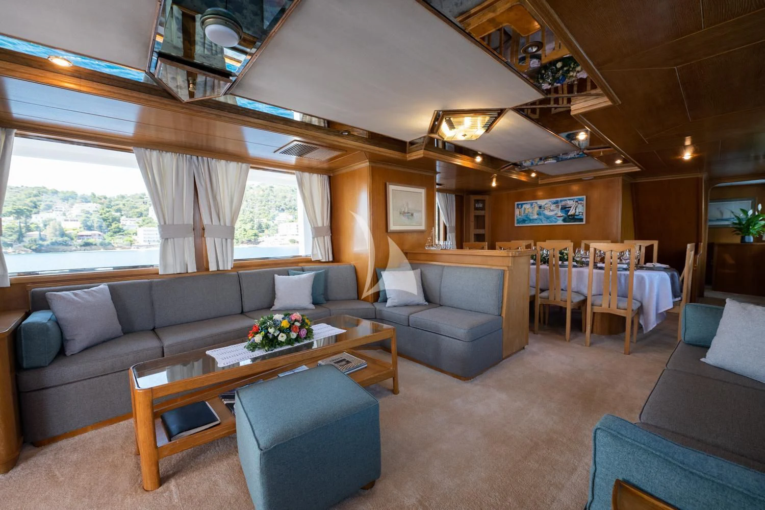 a living room with a couch and a coffee table aboard ELENA Yacht for Sale