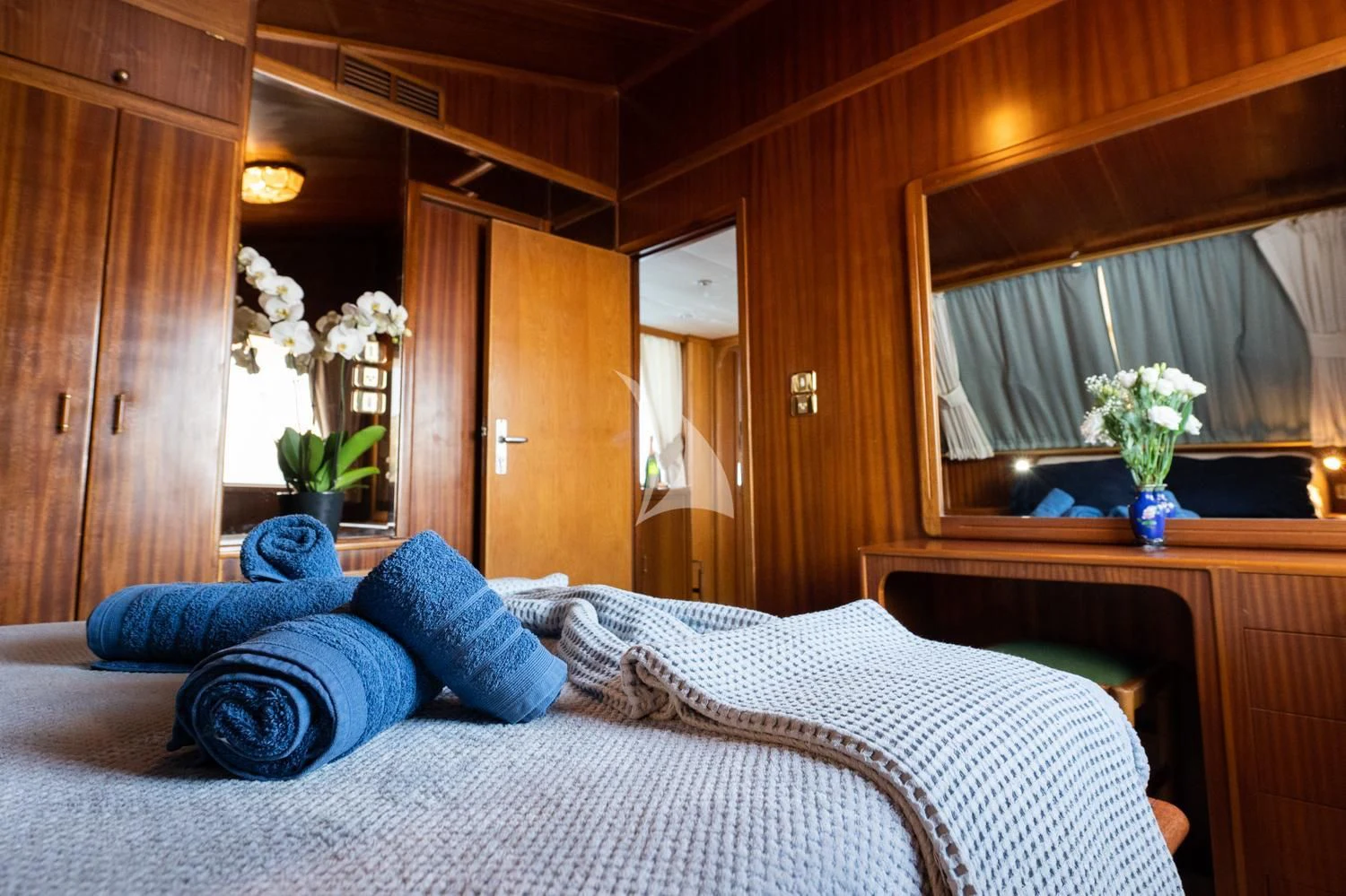 a bed with blue pillows aboard ELENA Yacht for Sale