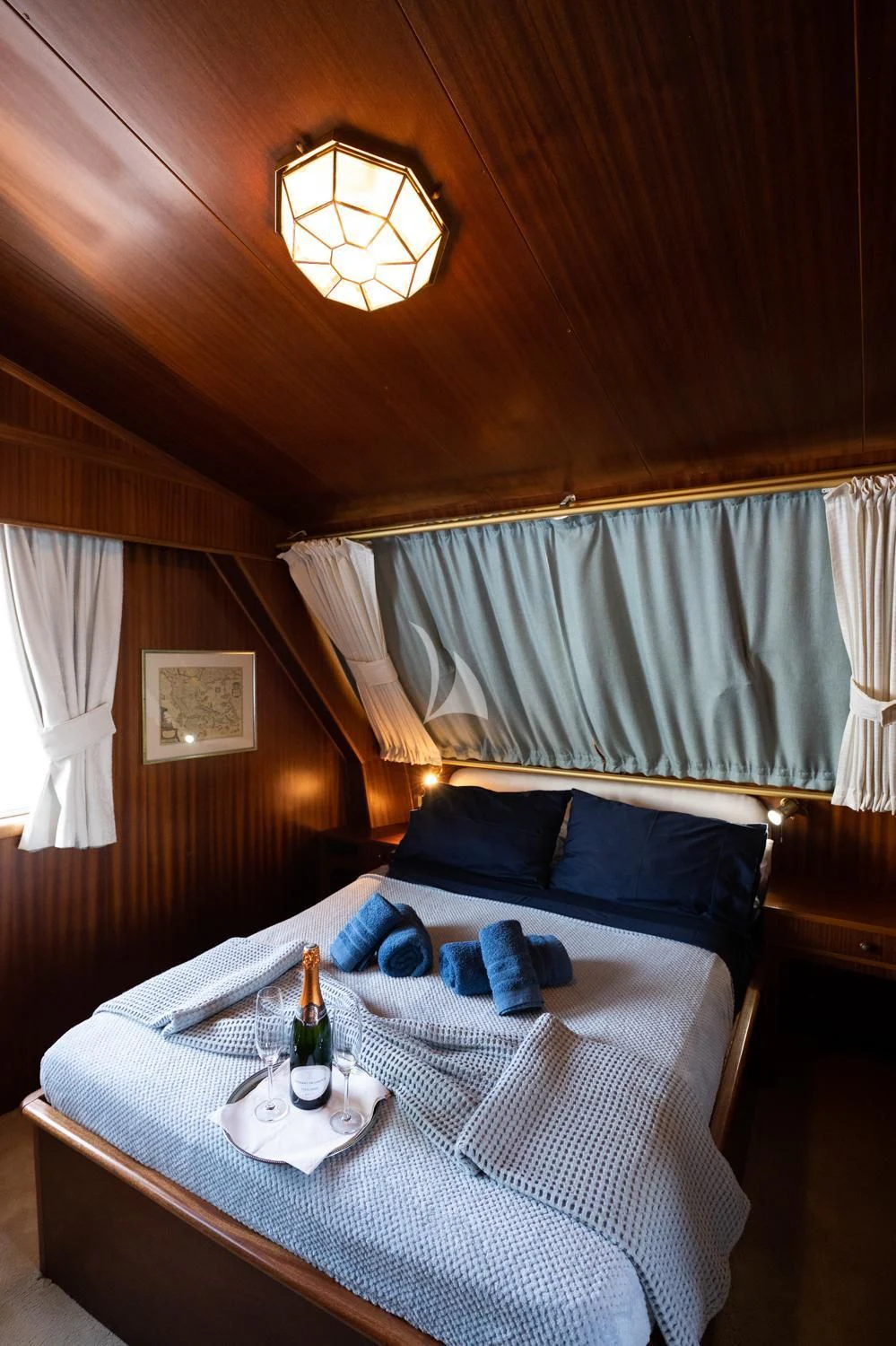 a bed with a bottle of wine aboard ELENA Yacht for Sale
