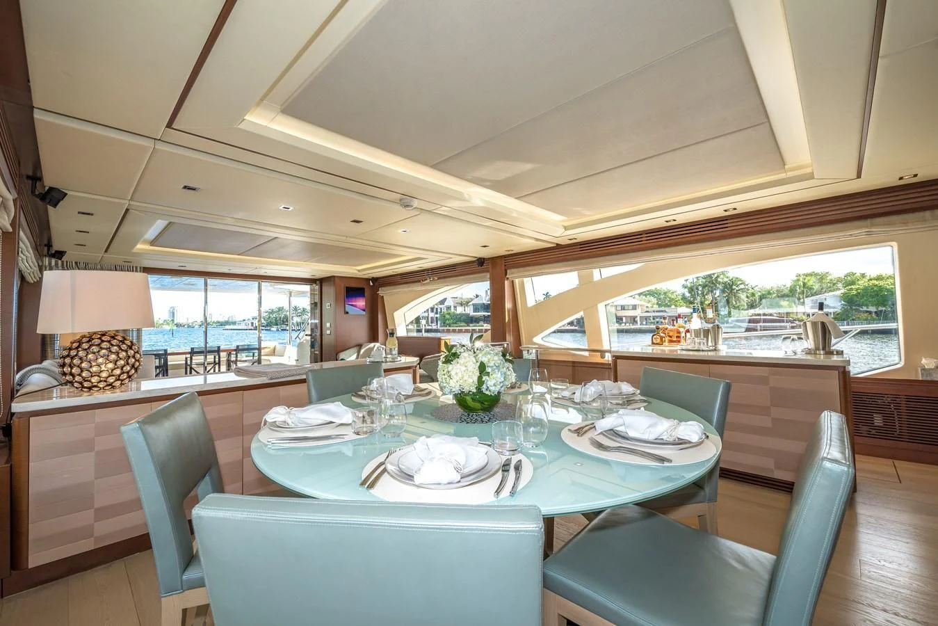 a large dining table with white plates aboard LIBERTY BLUE Yacht for Sale