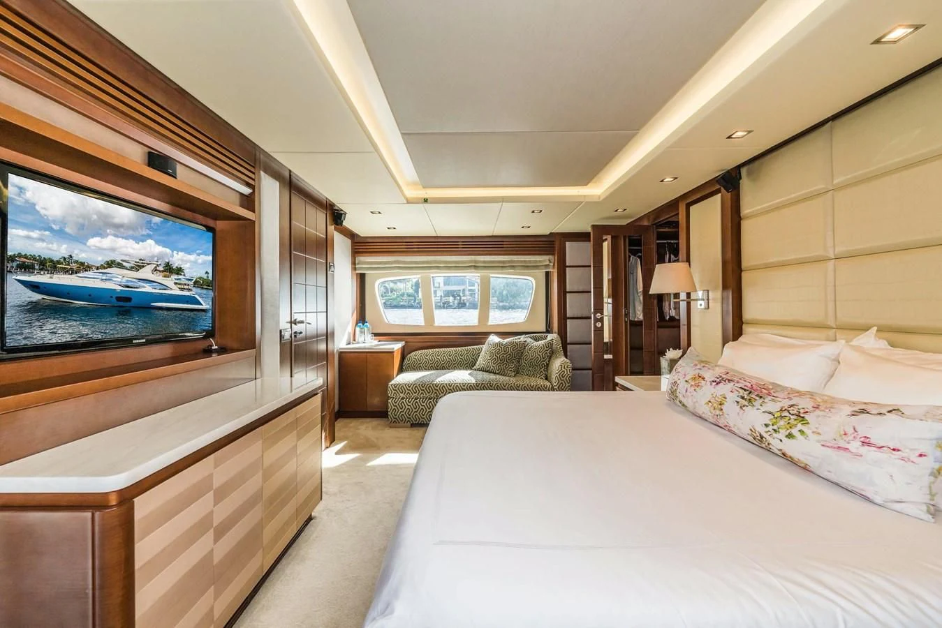 a bedroom with a large bed and a flat screen tv aboard LIBERTY BLUE Yacht for Sale