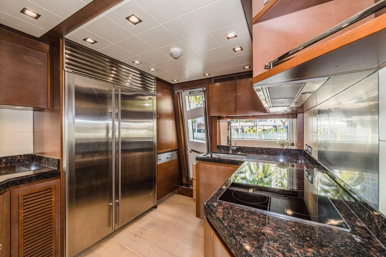 a kitchen with a large stainless steel refrigerator aboard LIBERTY BLUE Yacht for Sale