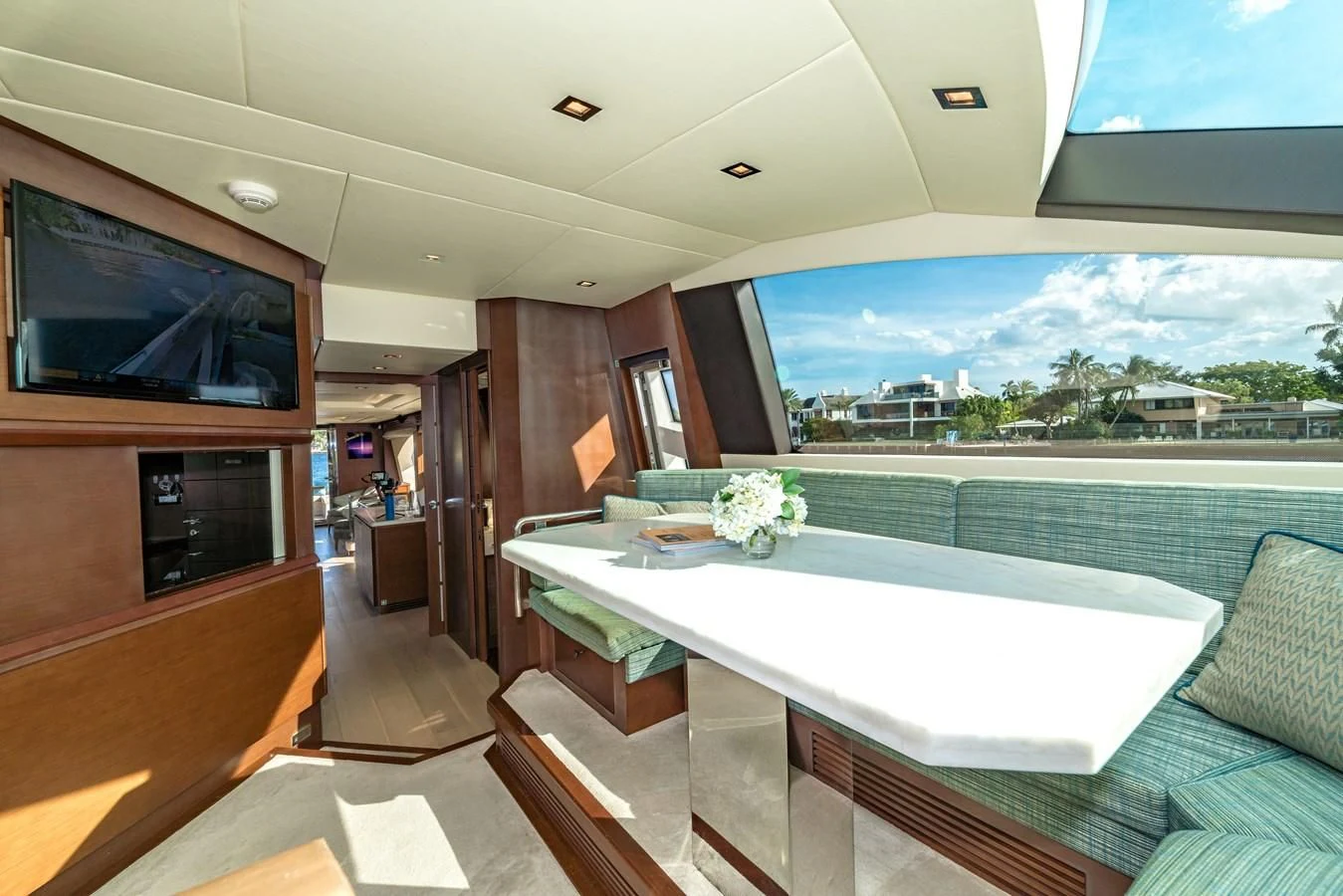 a room with a table and chairs aboard LIBERTY BLUE Yacht for Sale