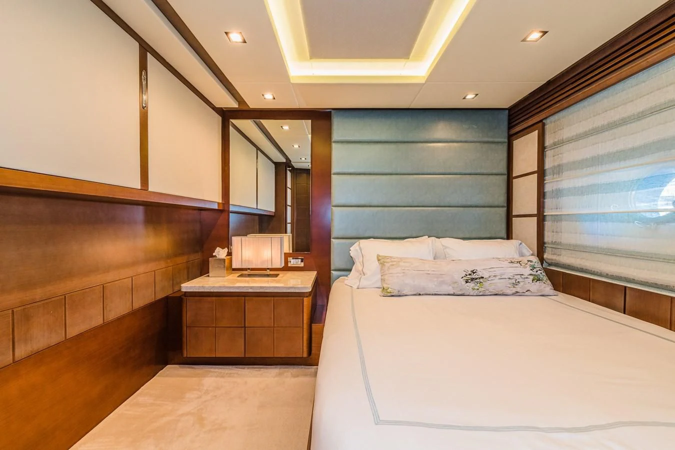 a bedroom with a bed and a dresser aboard LIBERTY BLUE Yacht for Sale
