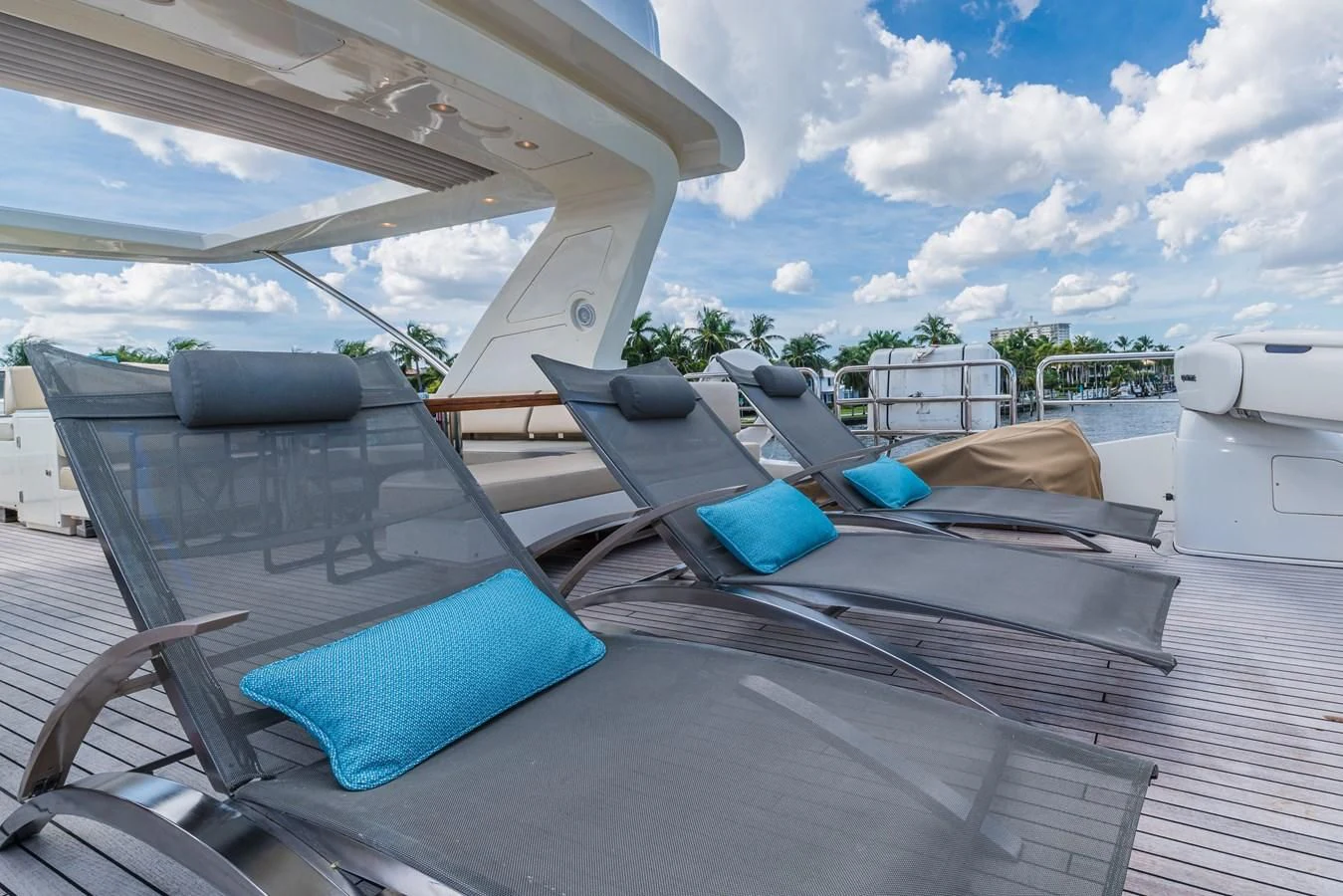 a deck with a chair and a boat on it aboard LIBERTY BLUE Yacht for Sale
