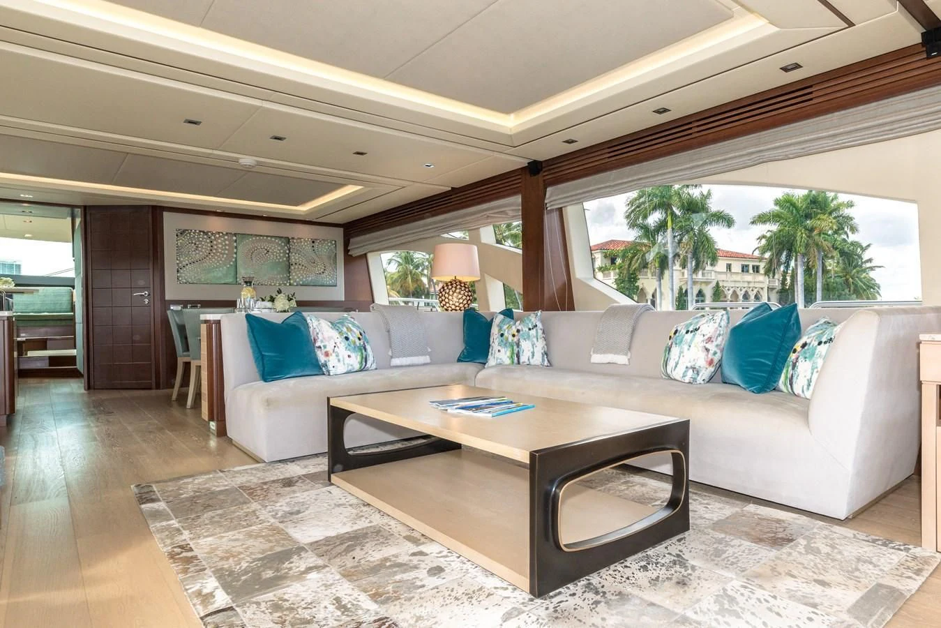 a living room with a couch and a table aboard LIBERTY BLUE Yacht for Sale