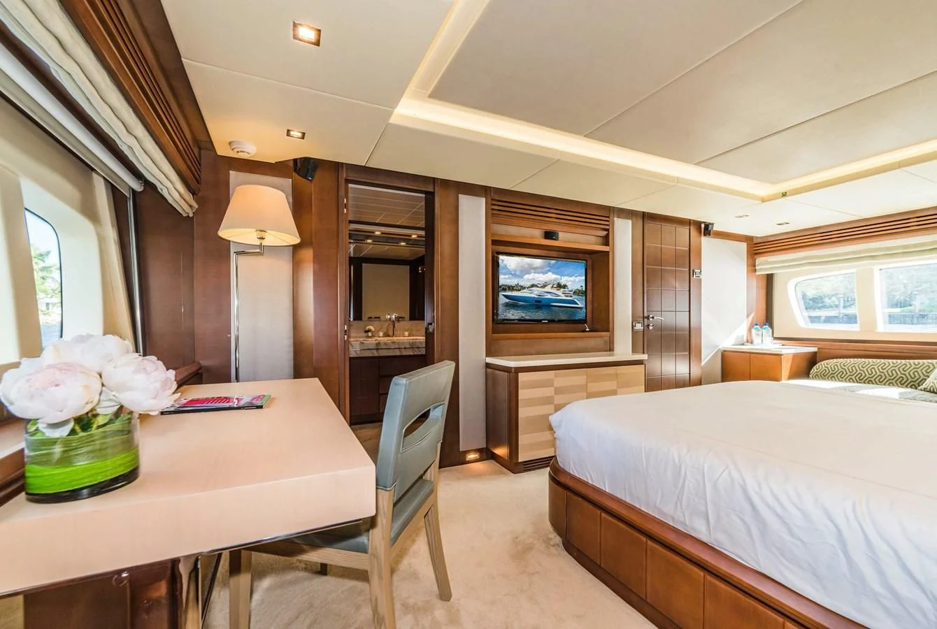 a bedroom with a bed and a television aboard LIBERTY BLUE Yacht for Sale