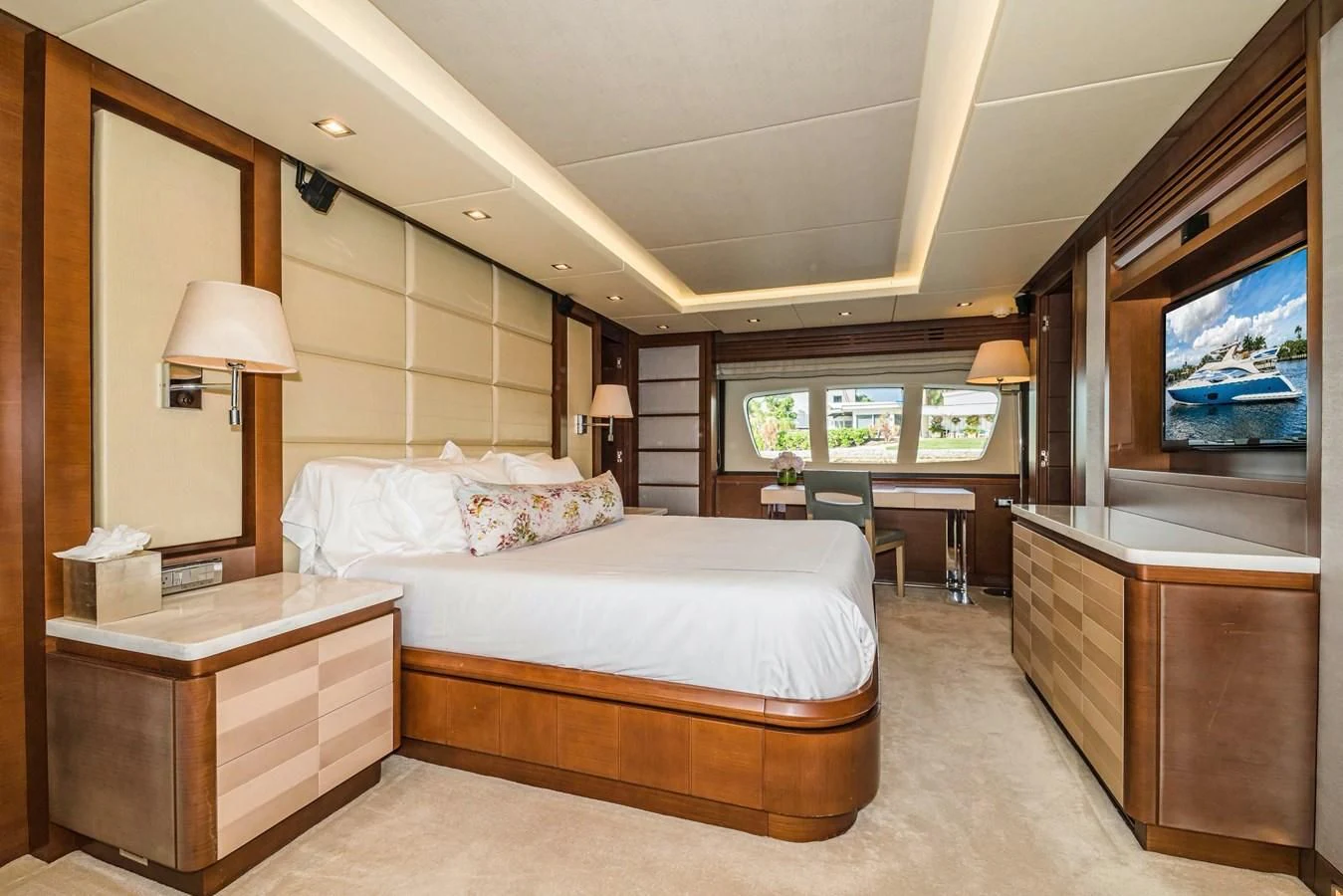 a bedroom with a bed and a desk aboard LIBERTY BLUE Yacht for Sale