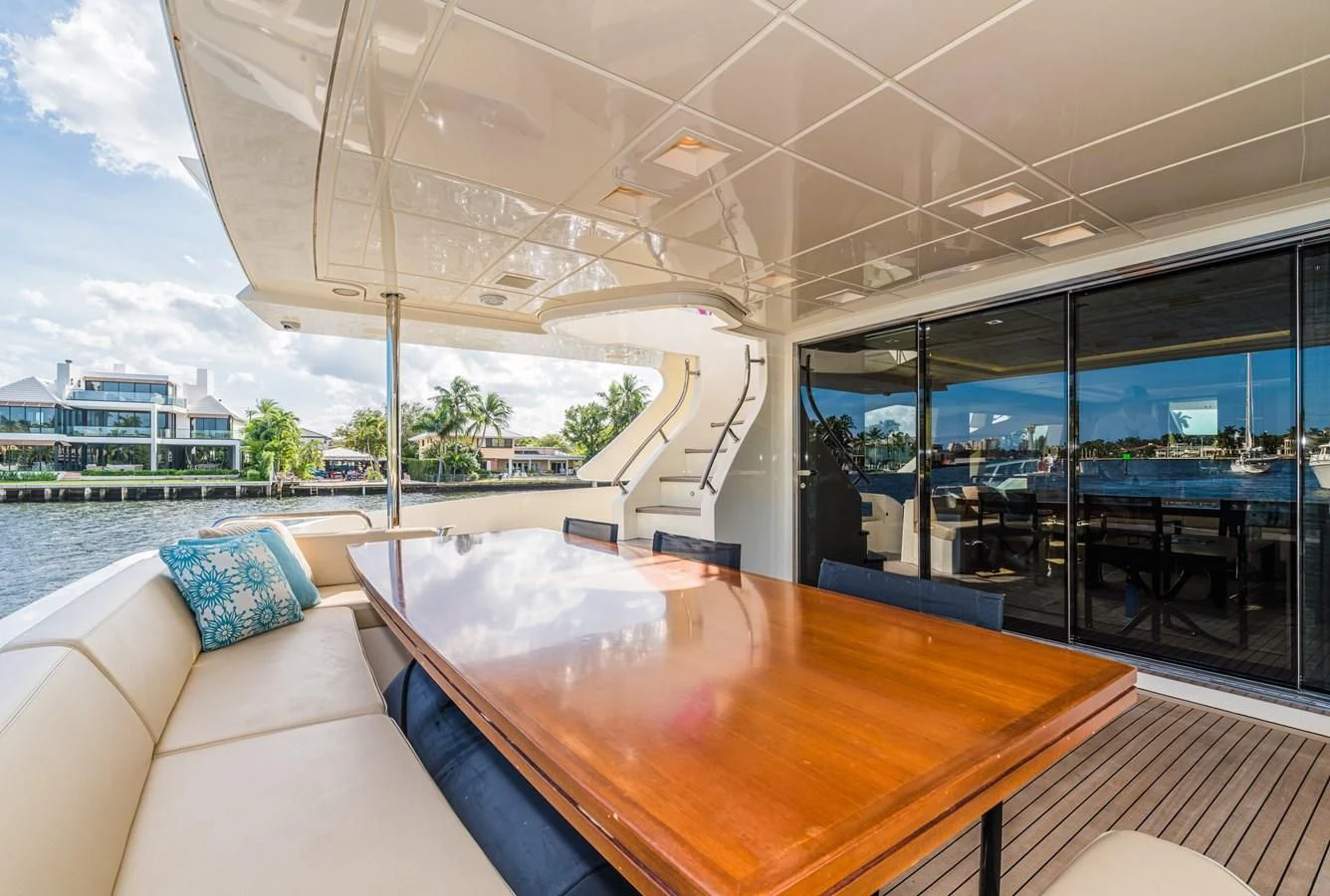 a room with a table and couches aboard LIBERTY BLUE Yacht for Sale