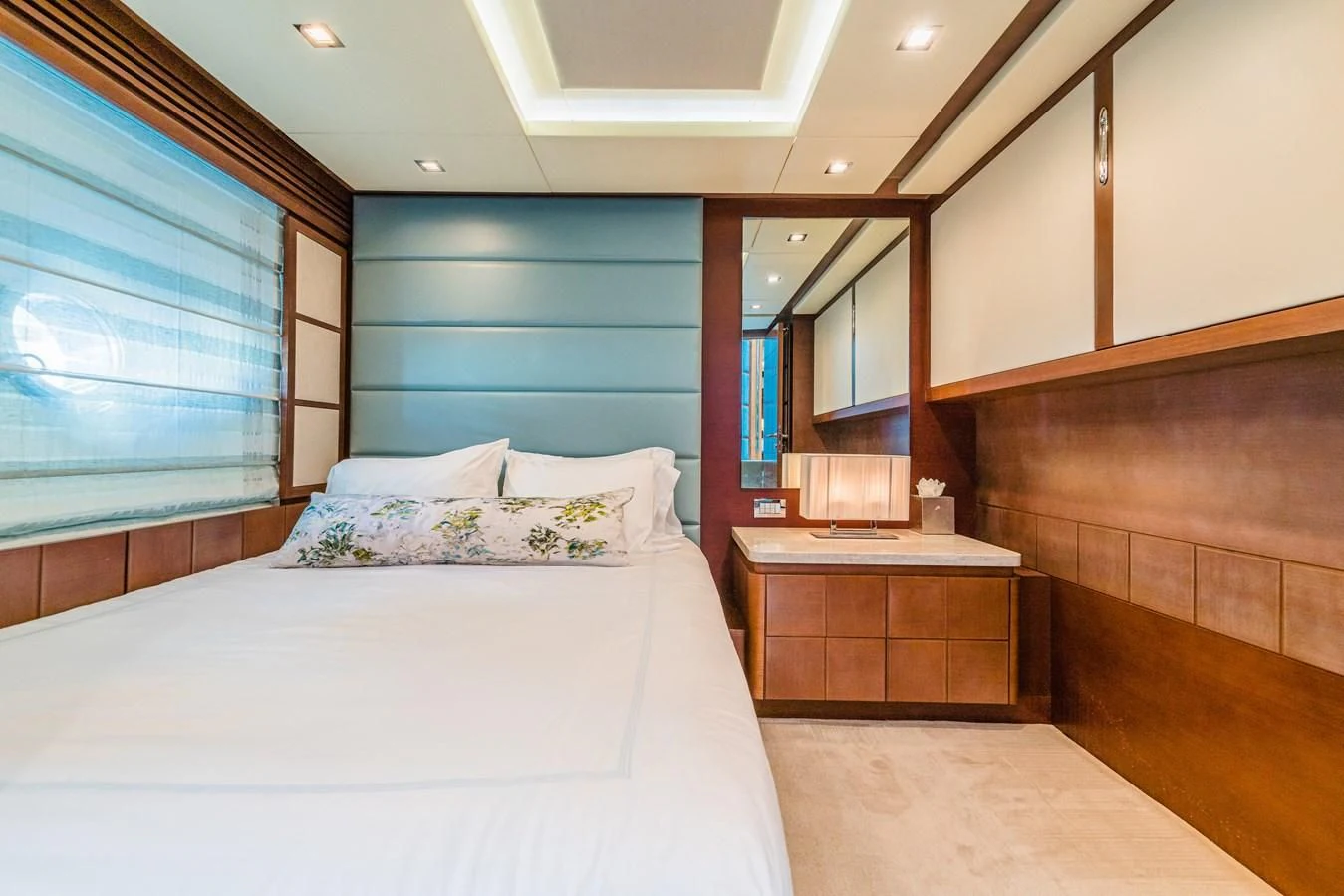 a bedroom with a bed and a dresser aboard LIBERTY BLUE Yacht for Sale