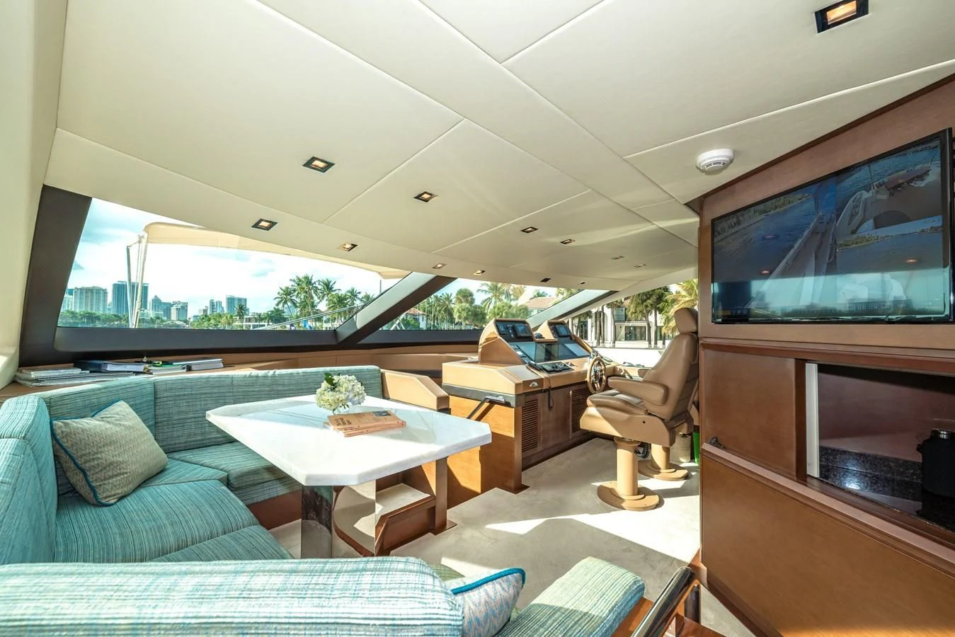 a living room with a large screen aboard LIBERTY BLUE Yacht for Sale