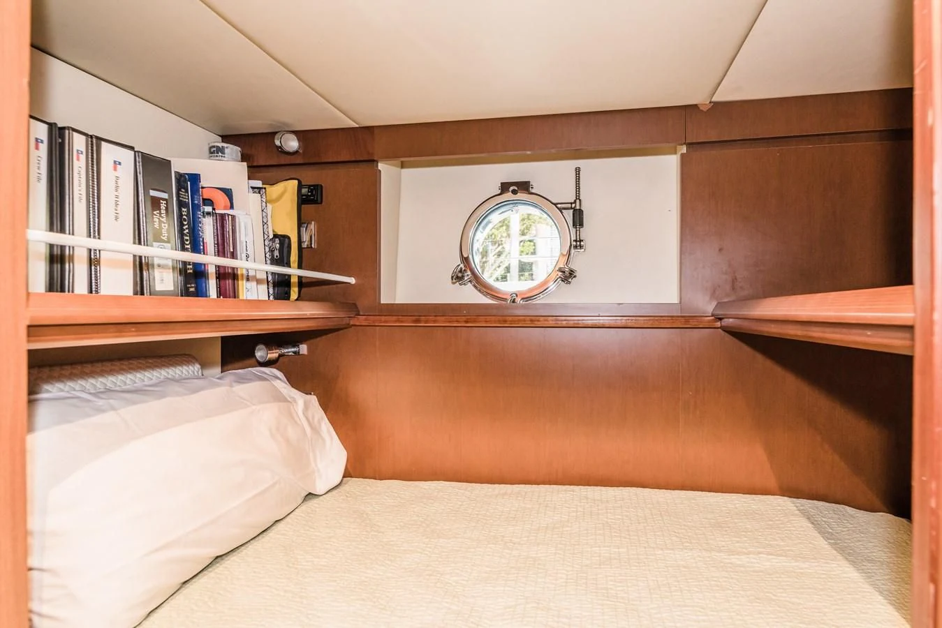 a bed with a mirror above it aboard LIBERTY BLUE Yacht for Sale