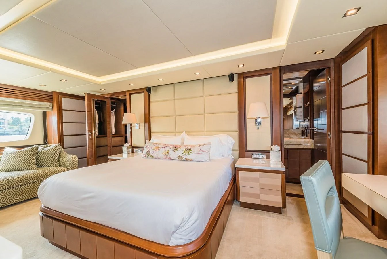 a bedroom with a bed and a couch aboard LIBERTY BLUE Yacht for Sale