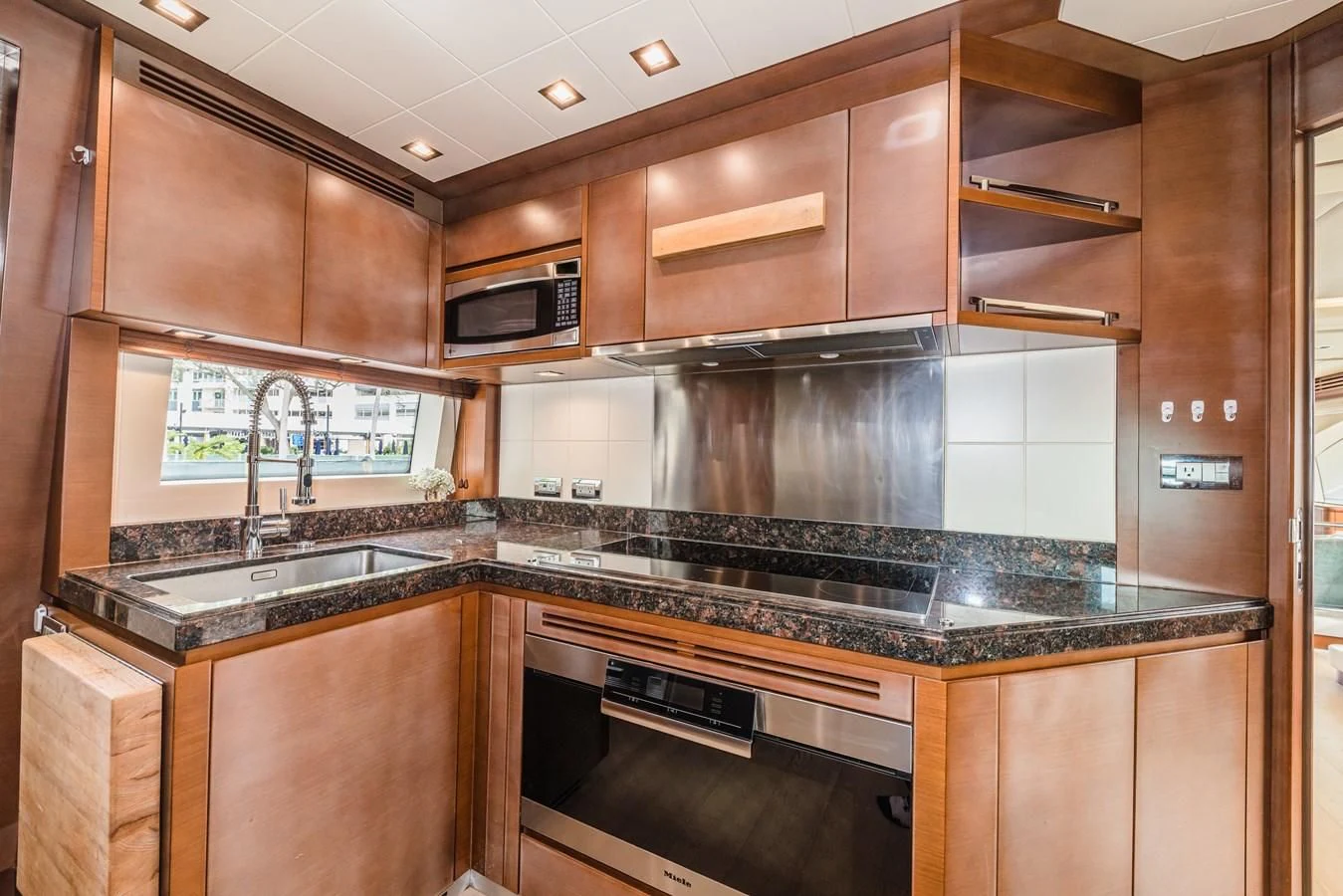 a kitchen with wooden cabinets aboard LIBERTY BLUE Yacht for Sale