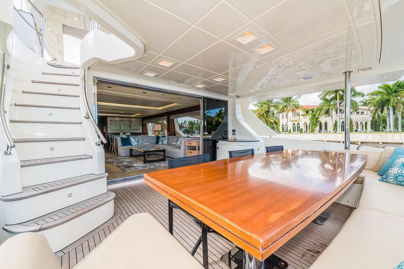 a large room with a table and chairs aboard LIBERTY BLUE Yacht for Sale