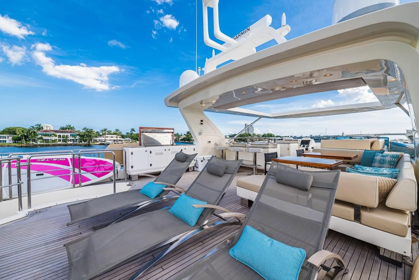 a deck with a boat and a chair on it aboard LIBERTY BLUE Yacht for Sale