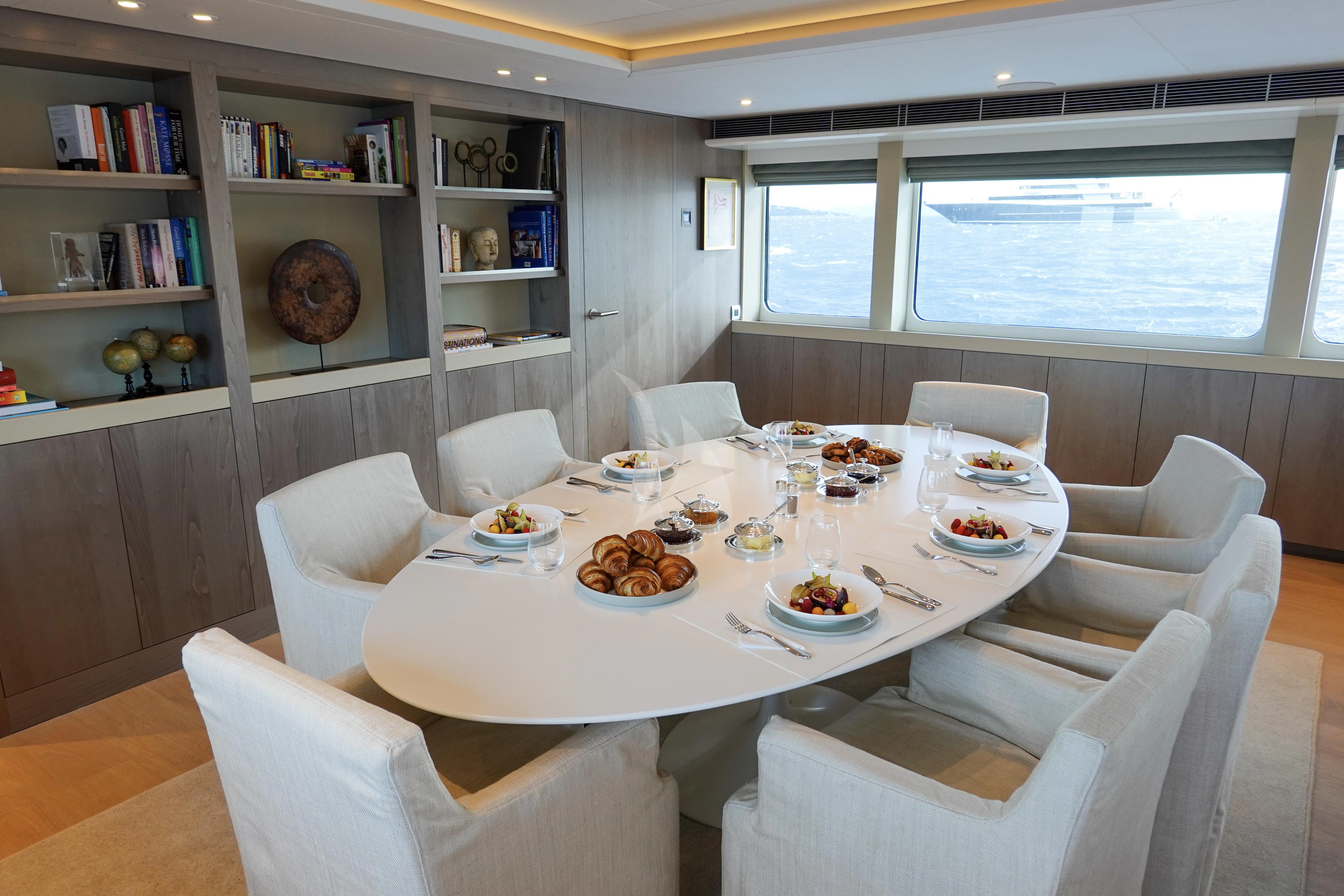 a dining room with a table and chairs aboard UNEXPECTED Yacht for Sale