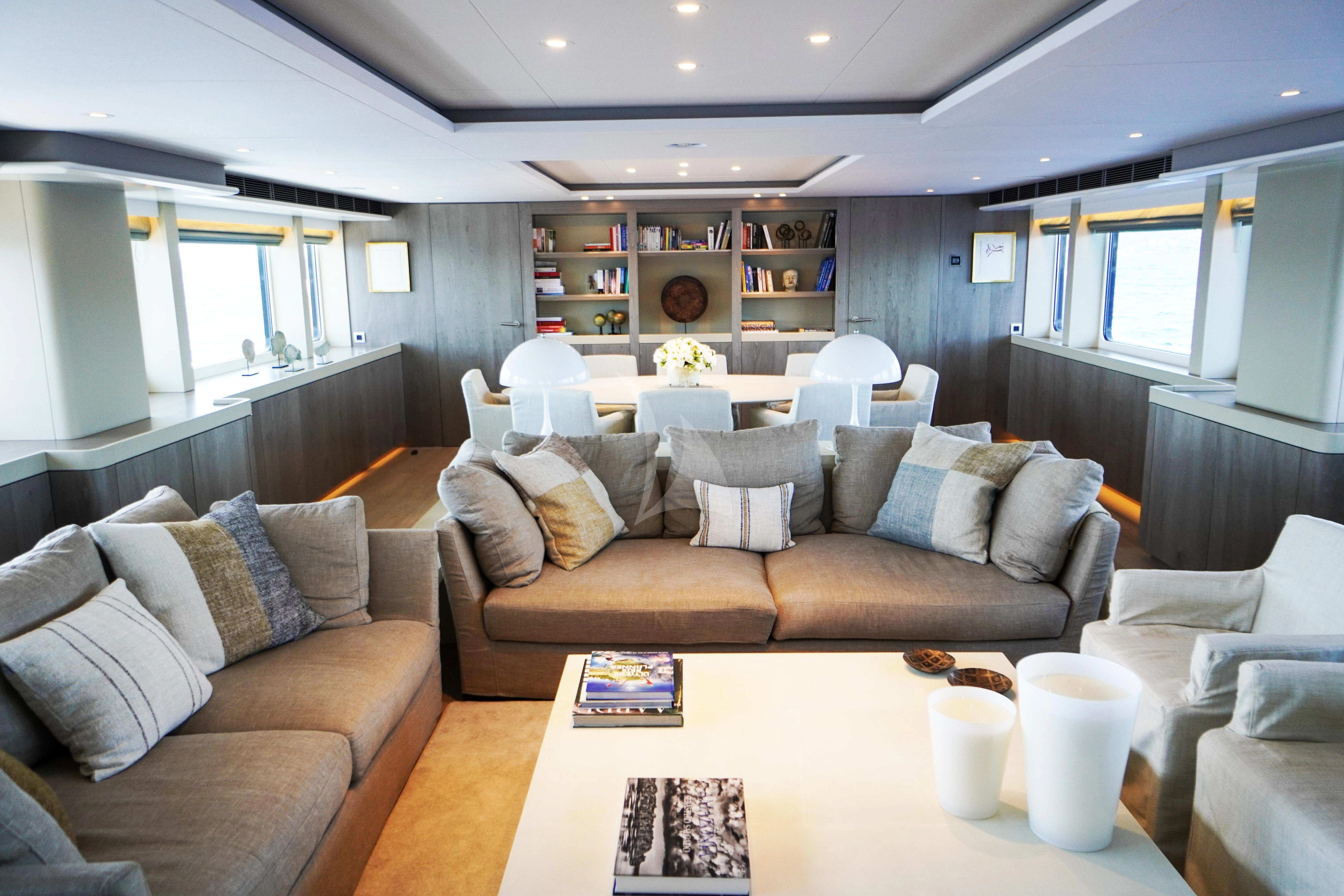 a living room with a couch and a coffee table aboard UNEXPECTED Yacht for Sale