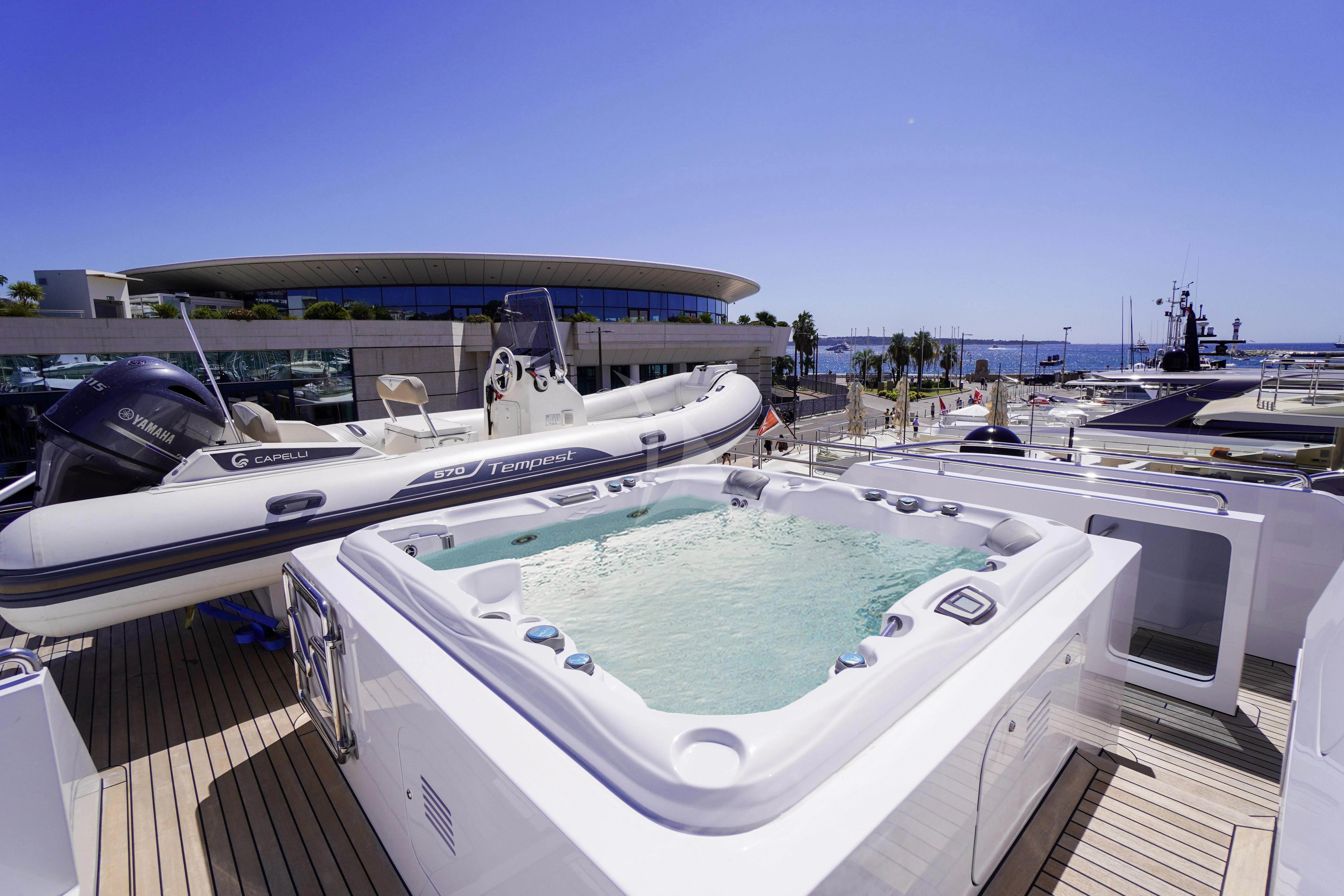 a large white boat on a dock aboard UNEXPECTED Yacht for Sale