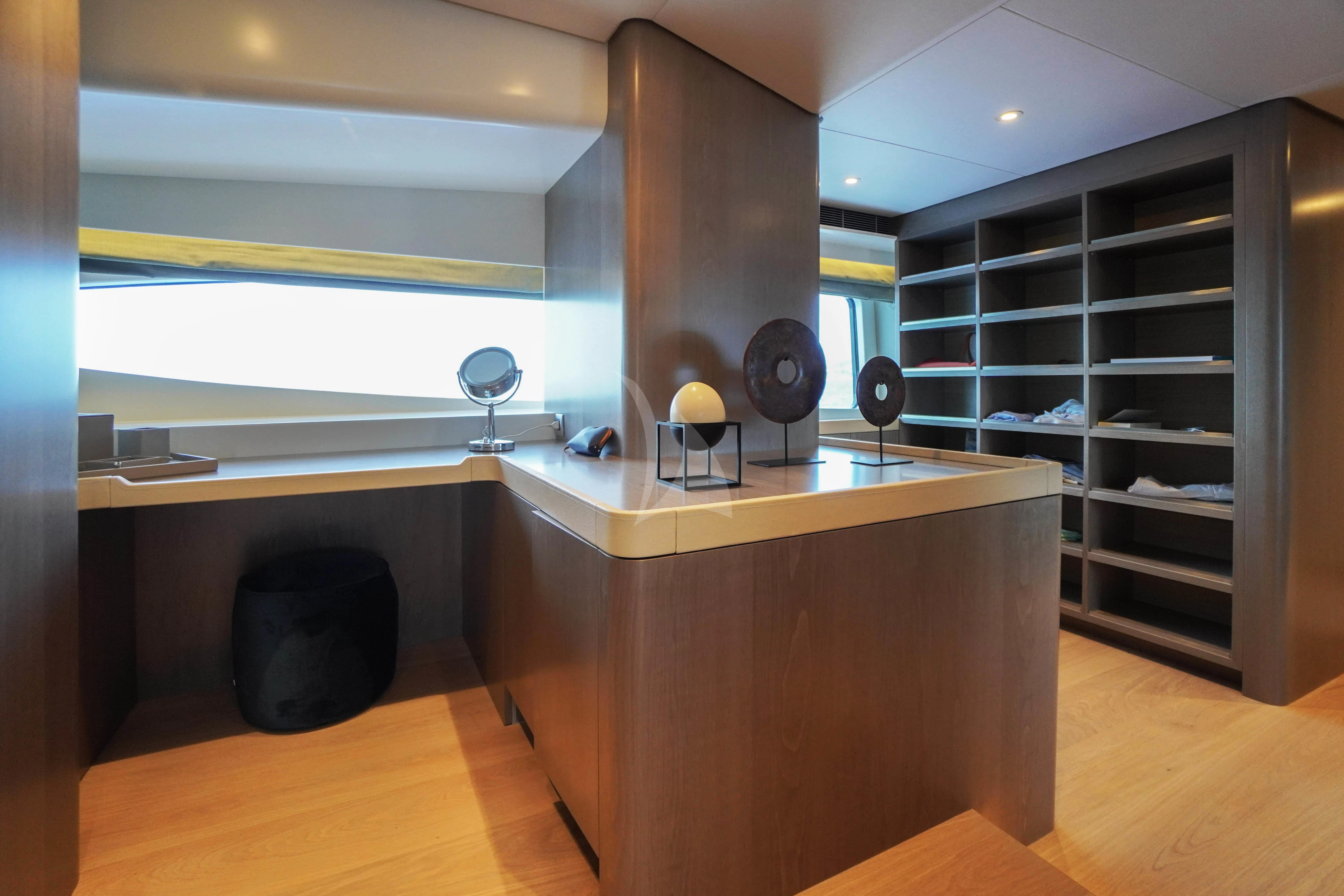 a room with a table and a fan aboard UNEXPECTED Yacht for Sale